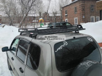 Багажник Уникар для ВАЗ-2123 Chevrolet Niva, LADA Niva Travel с боковым ограждением с сеткой на штатные места